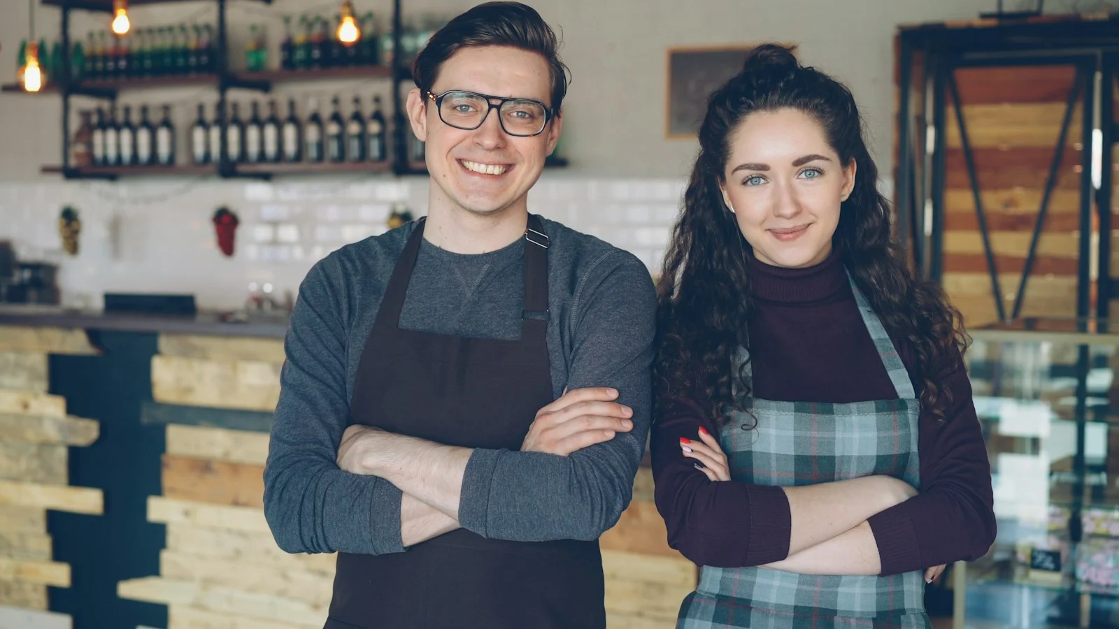 When to franchise your business Two café owners standing proudly in their café